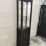 Old wooden window of black patina store two doors