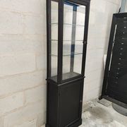 Old wooden window of black patina store two doors