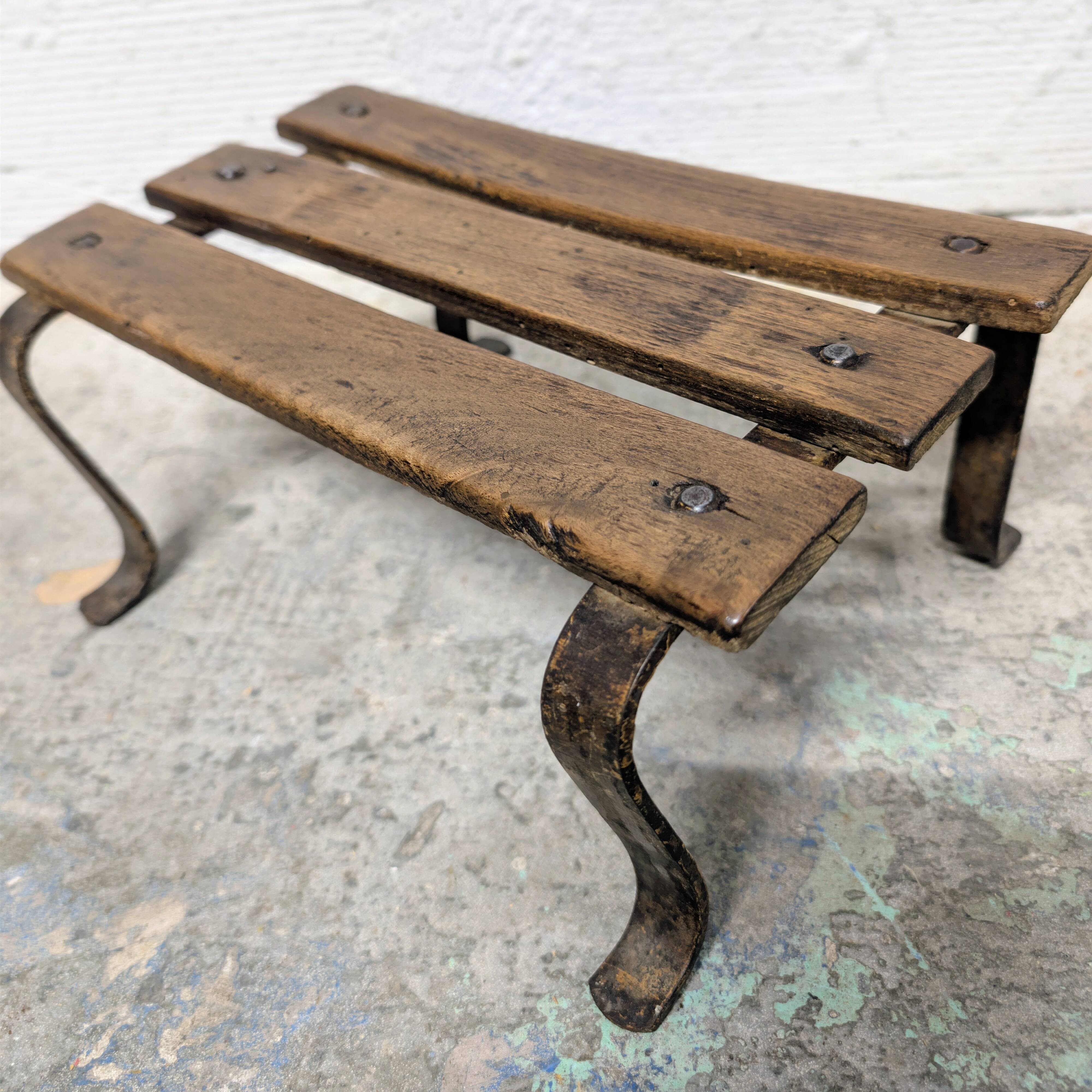 Antique iron and wood footrest