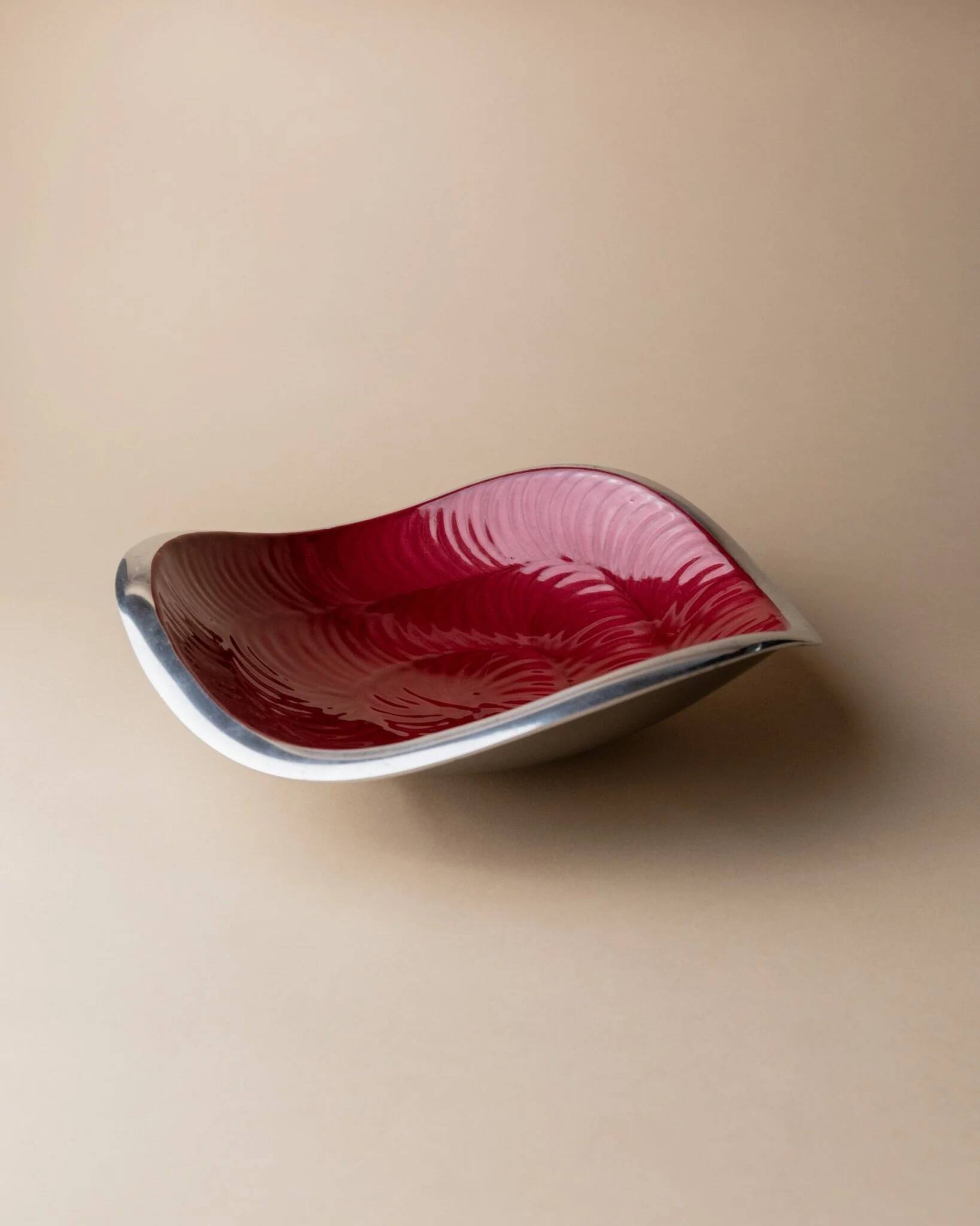 Red enameled steel bowl with textured interior and silver exterior; vintage Italian 1970s design