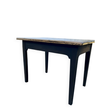 Renovated black and raw wood farmhouse table