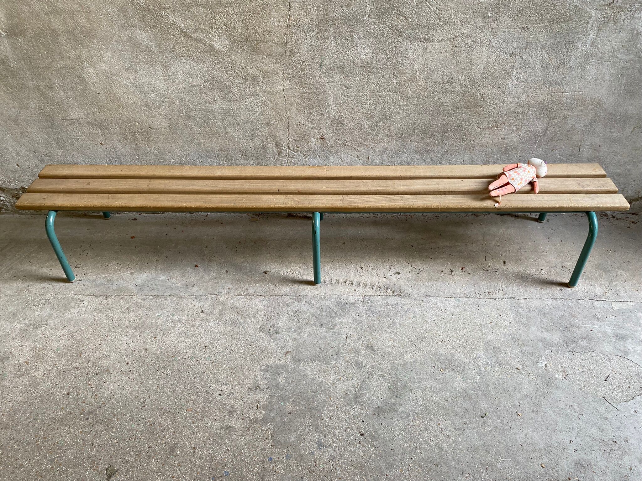 Vintage wood kindergarten bench and tubular structure in long