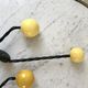 Duo of hooks balls in yellow wood and black iron 60s