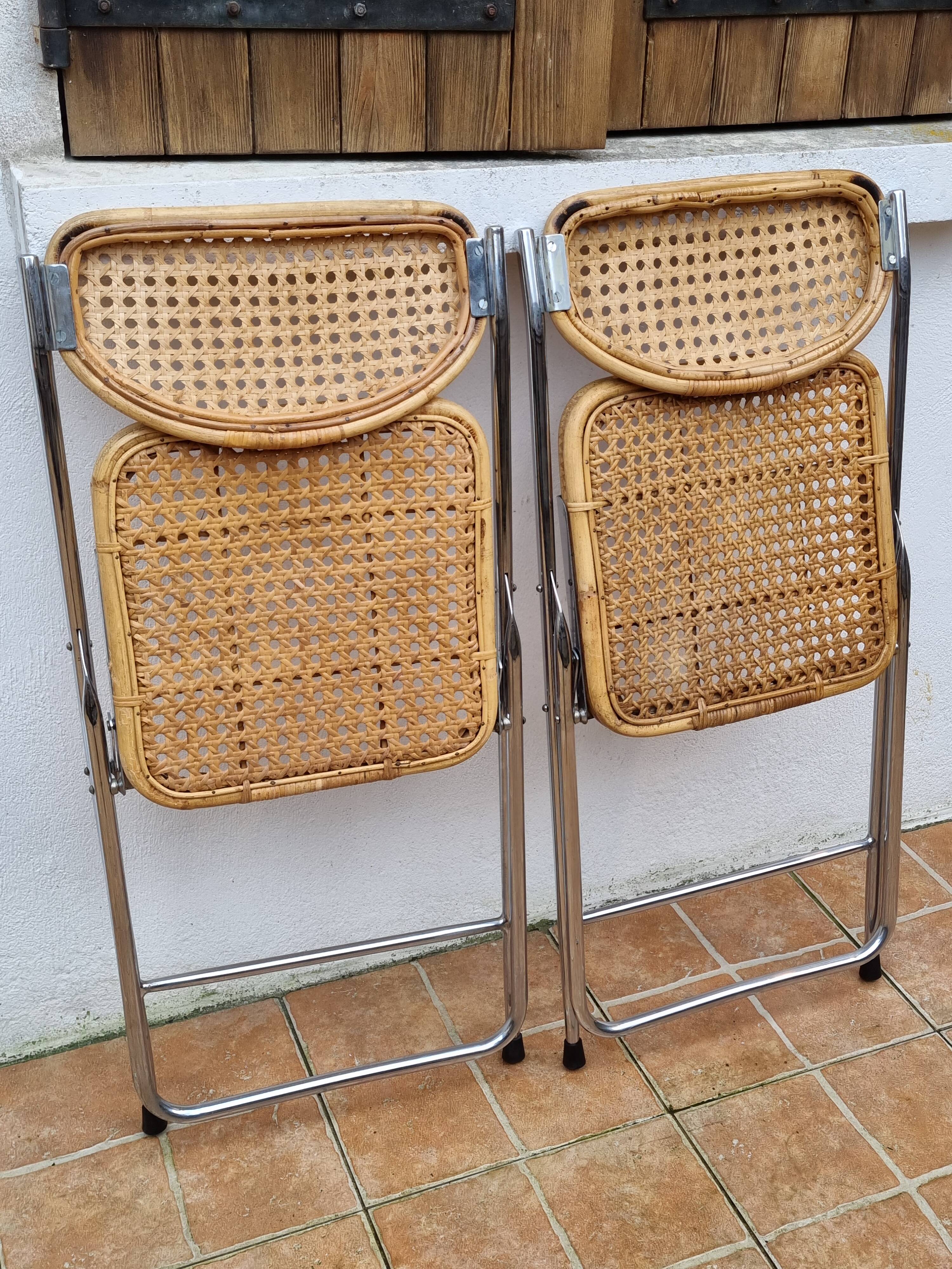 Pair of vintage metal and cane folding chairs
