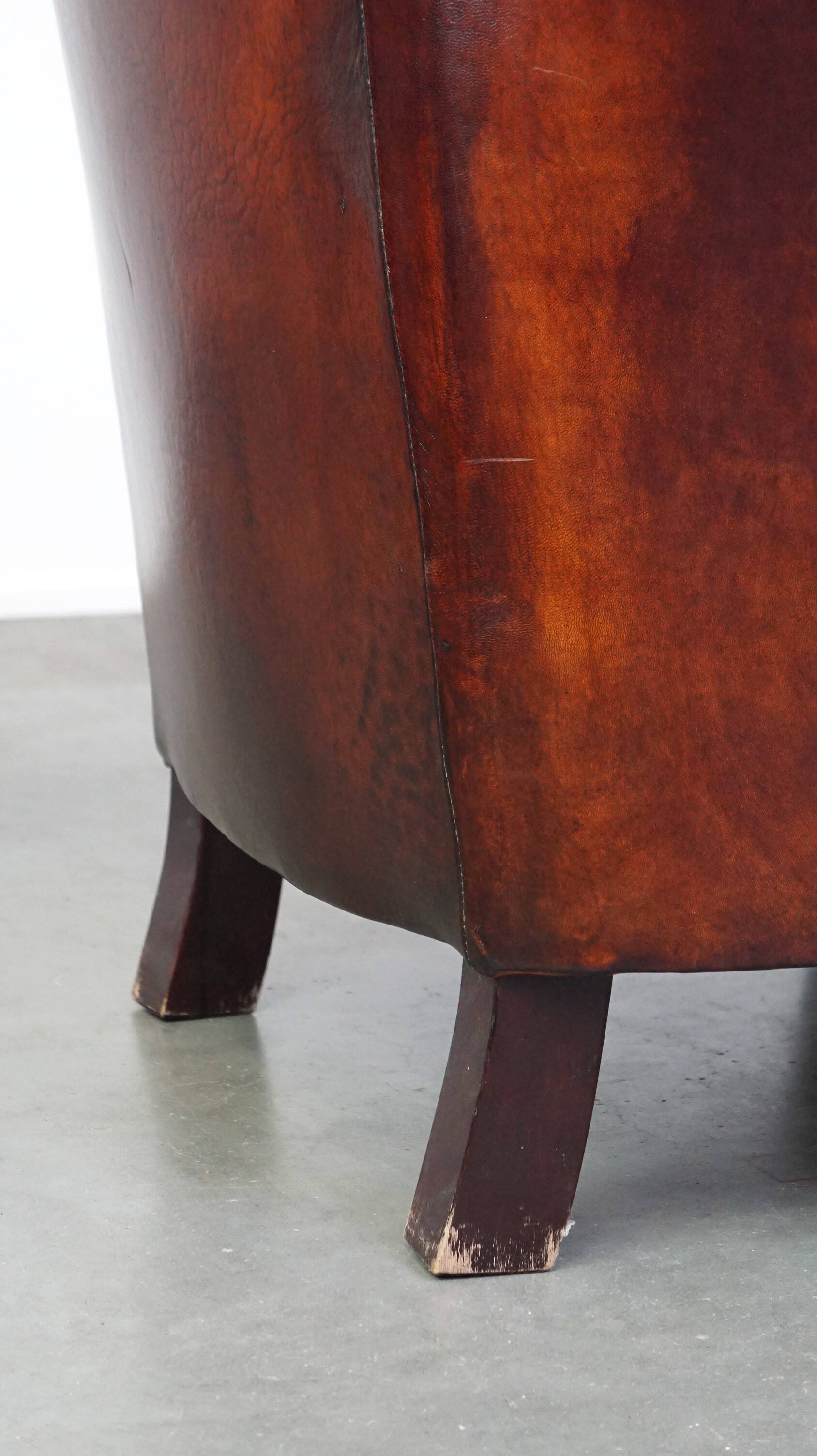 Very luxurious dark brown sheepskin club chair with a more than beautiful patina