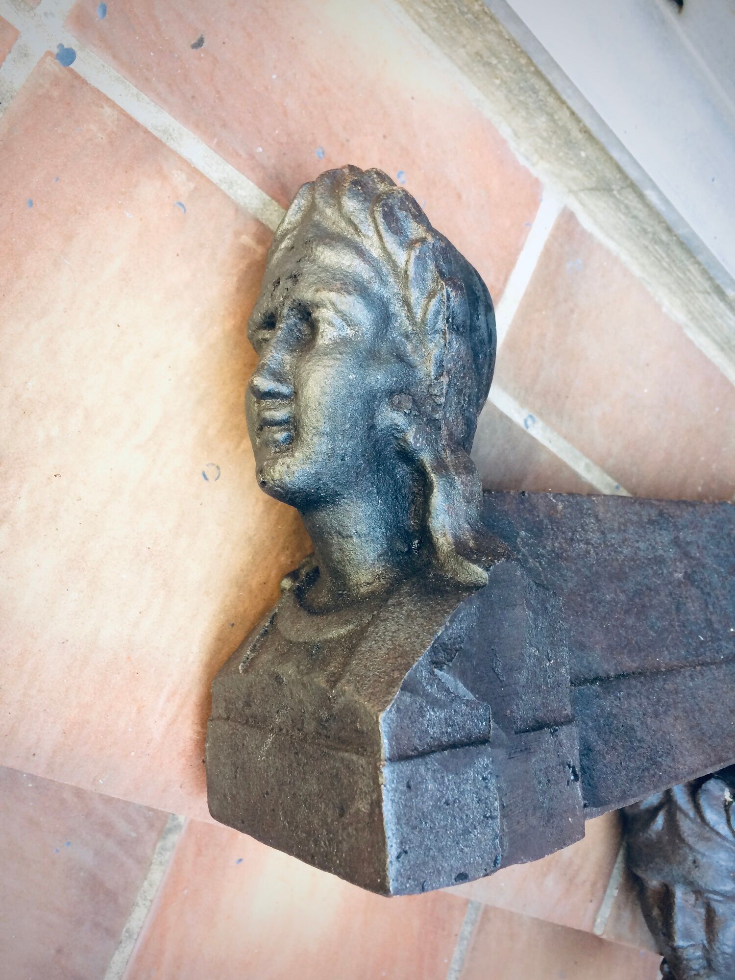 Pair of cast-iron chenet characters with laurels