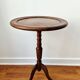 Small tripod wooden table with a vintage round top -