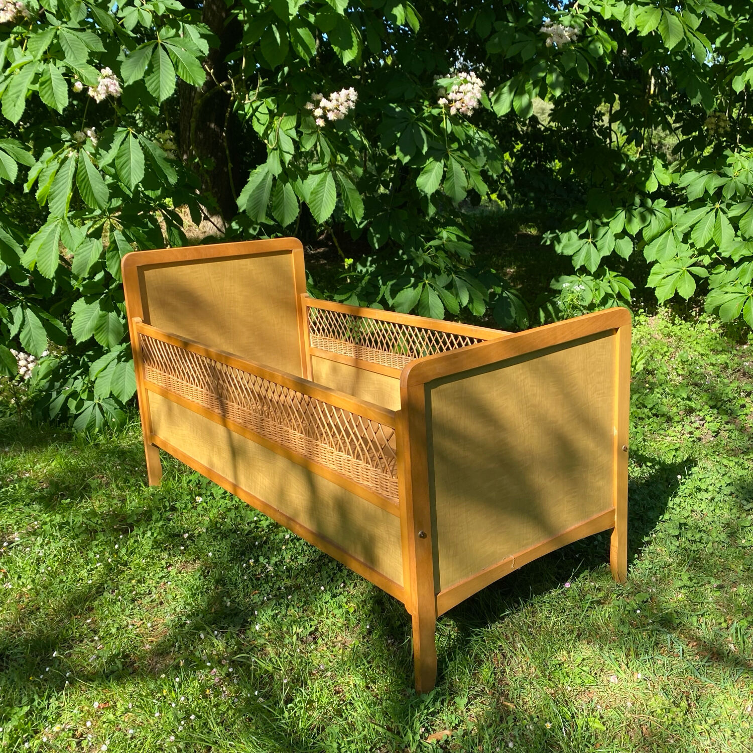 Vintage wooden and rattan baby cot from the 1960s.