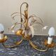 Golden metal chandelier decorated with flowers