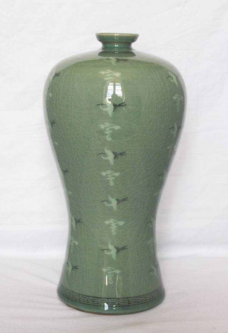 Korean vase in crackled celadon with a pattern of ducks and clouds.