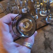 12 smoked glass stemmed glasses from the 70s and 80s.