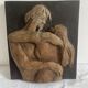 Wood sculpture bas-relief of man, woman, and child, signed.