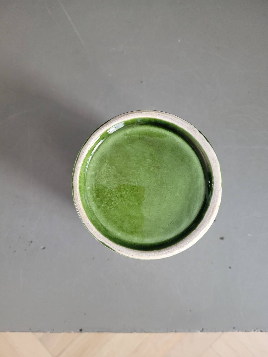 Green glazed ceramic flowerpot on stand