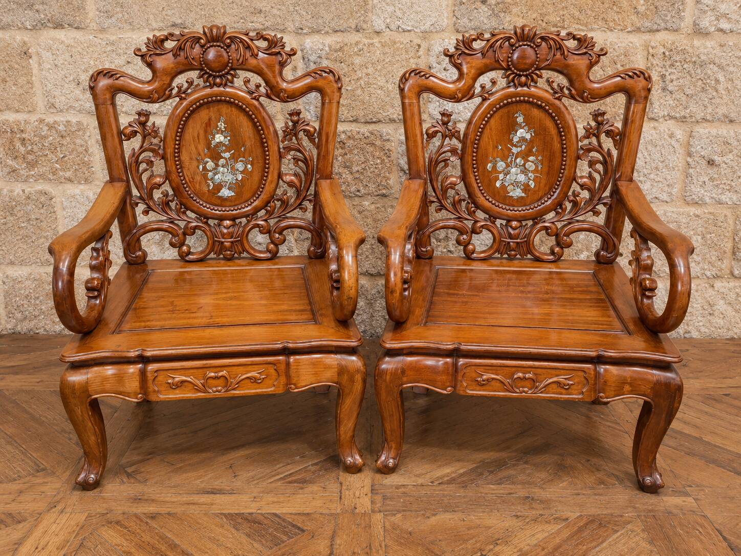 Pair of Asian armchairs in carved wood with mother-of-pearl inlays.