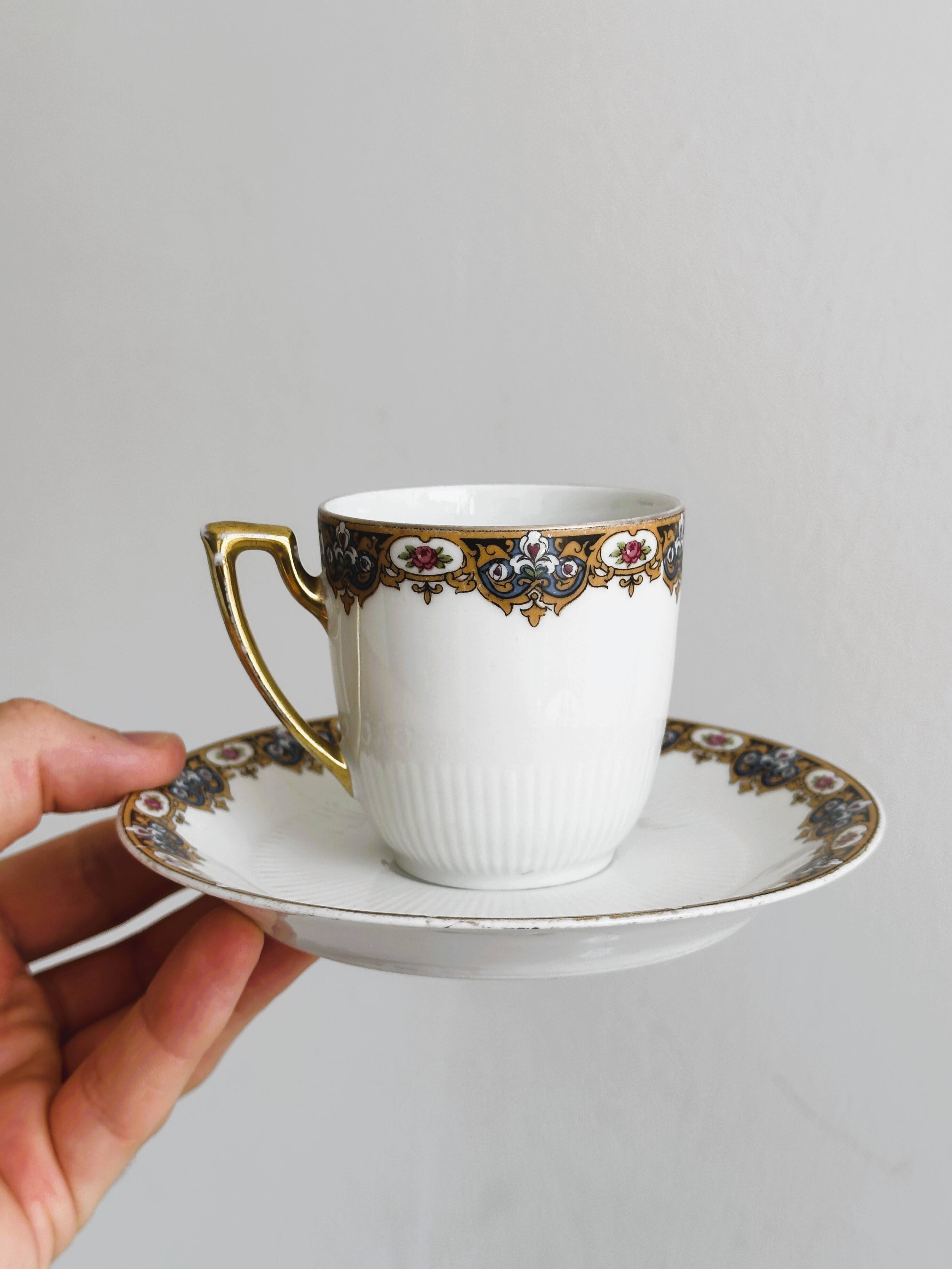 7 Limoges porcelain cups and saucers with gold decoration and floral motif.
