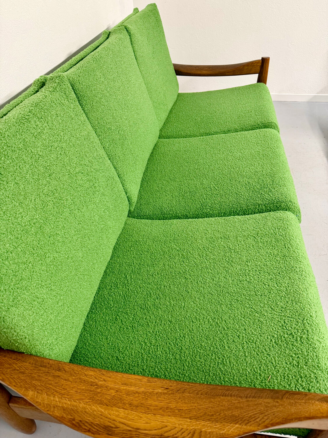 Living room sofa and Scandinavian design armchairs from the 1960s in green boucle.