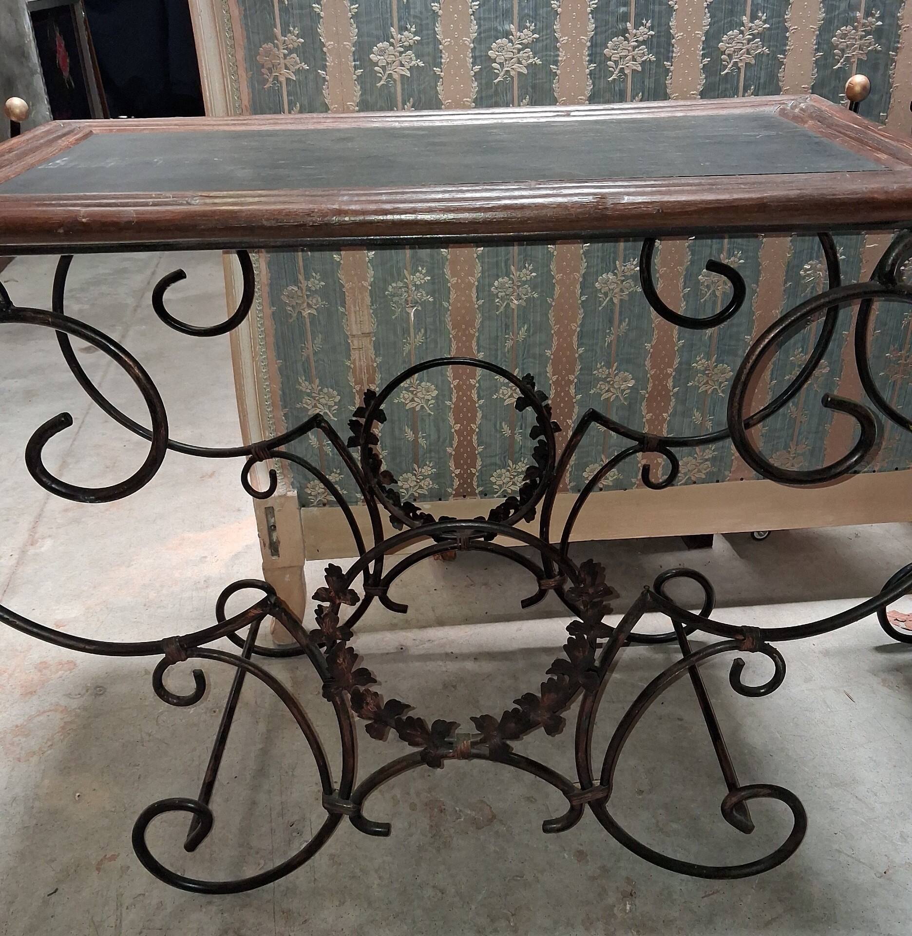 Pair of wrought iron and blackened wood consoles from the mid-20th century.