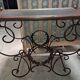 Pair of wrought iron and blackened wood consoles from the mid-20th century.