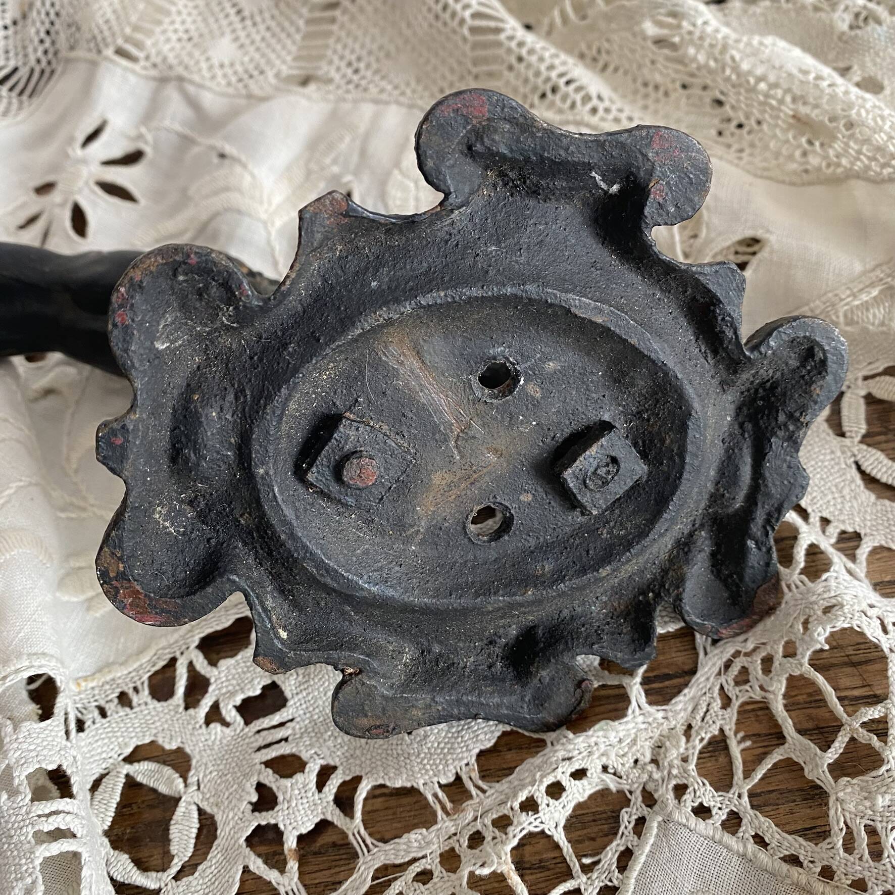 Antique cast iron coat hook with swimmer and shell basin.