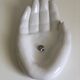 Empty white enamelled ceramic pocket in the shape of a large hand, 1990