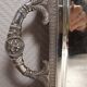 Silver-plated service tray with handles, neoclassical decoration.