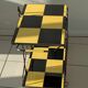 Vintage black and yellow checkered rolling bar trolley