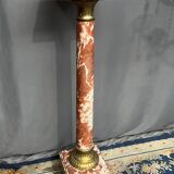 Marble pedestal decorated with gilded brass.