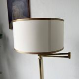 Floor lamp with articulated arm in brass-plated metal