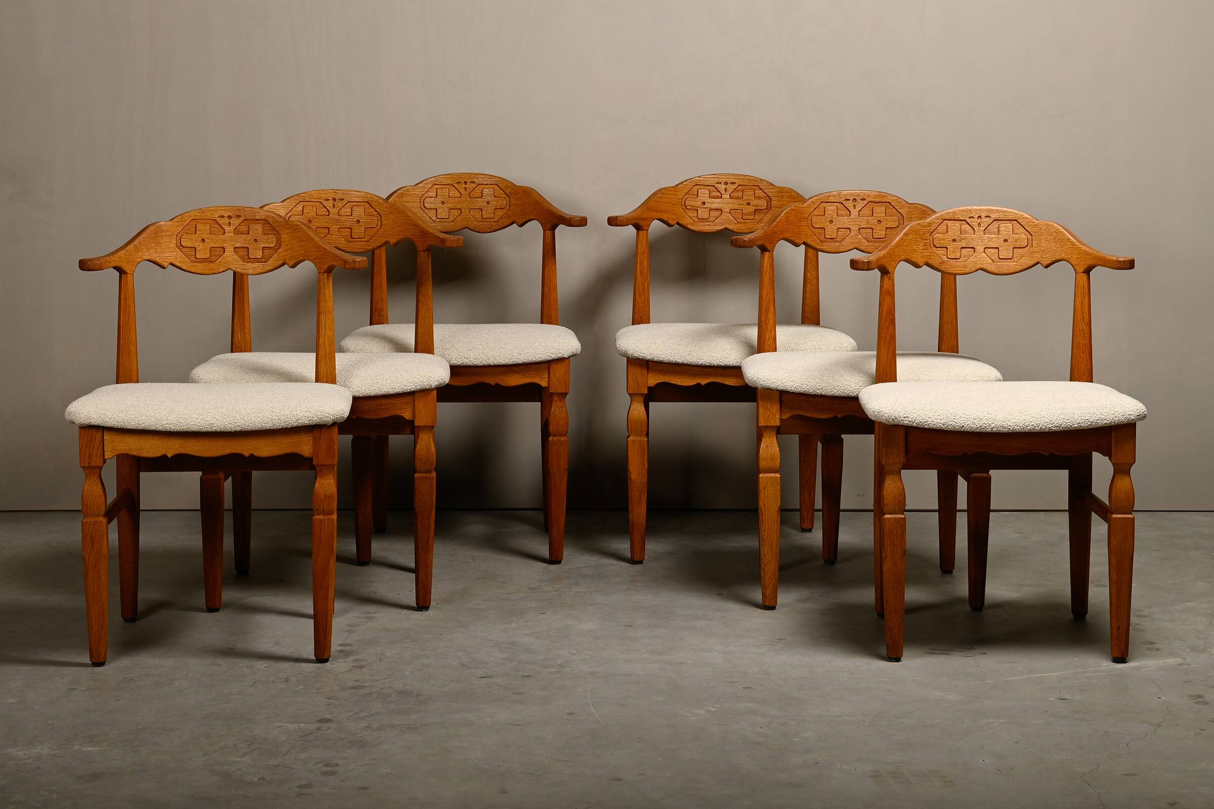 Henning Kjærnulf dining chairs set in Oak and Off White Bouclé, Denmark, 1960s