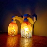 Pair of Art Deco wall sconces in multicoloured porcelain and frosted glass.