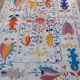 White suzani kilim rug with embroidered colorful patterns