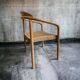 solid wood chair with woven seat and armrests