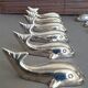 Lot 12 knife holders in the shape of a stylized whale or fish