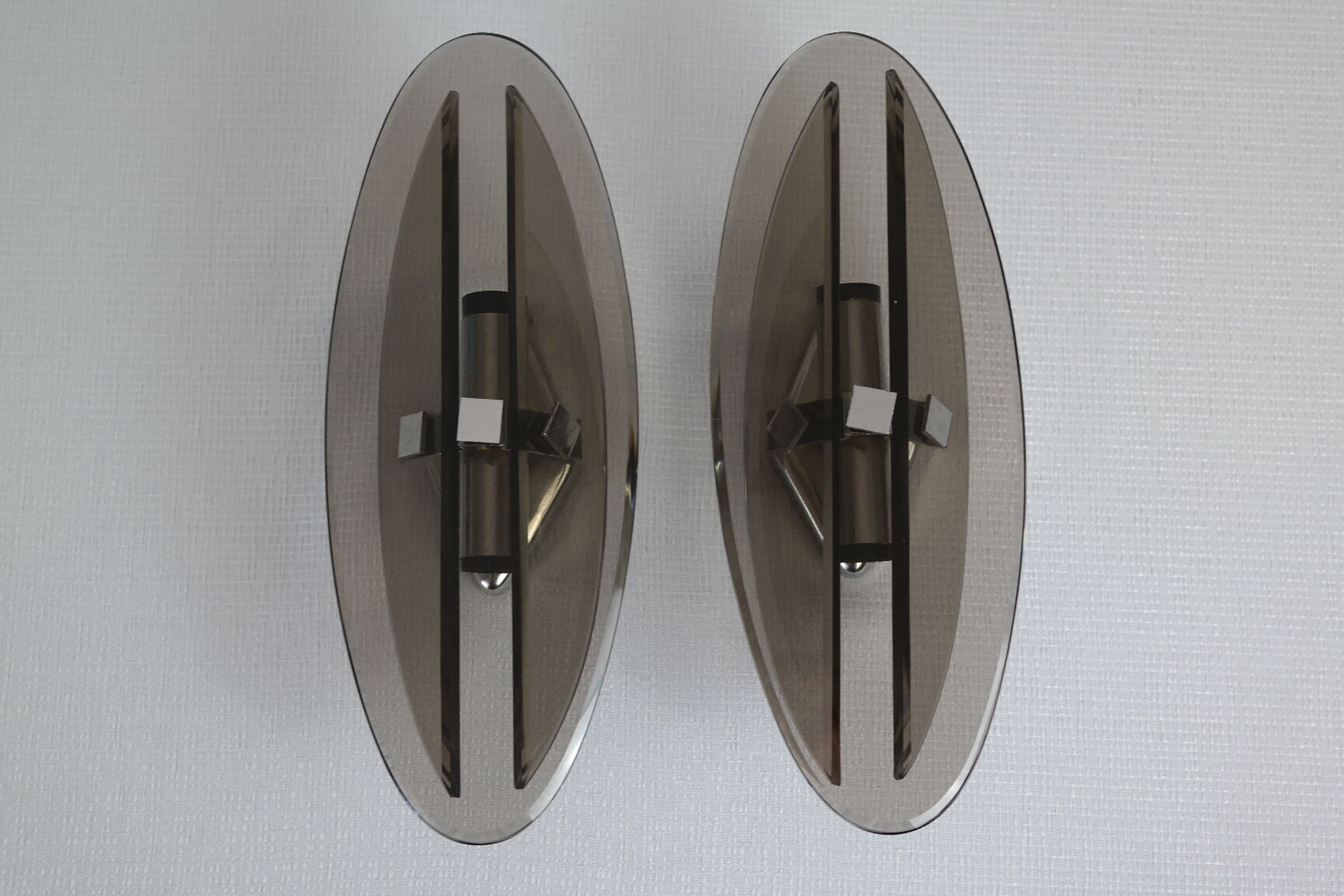 Pair of smoked glass and vintage chrome wall lamps