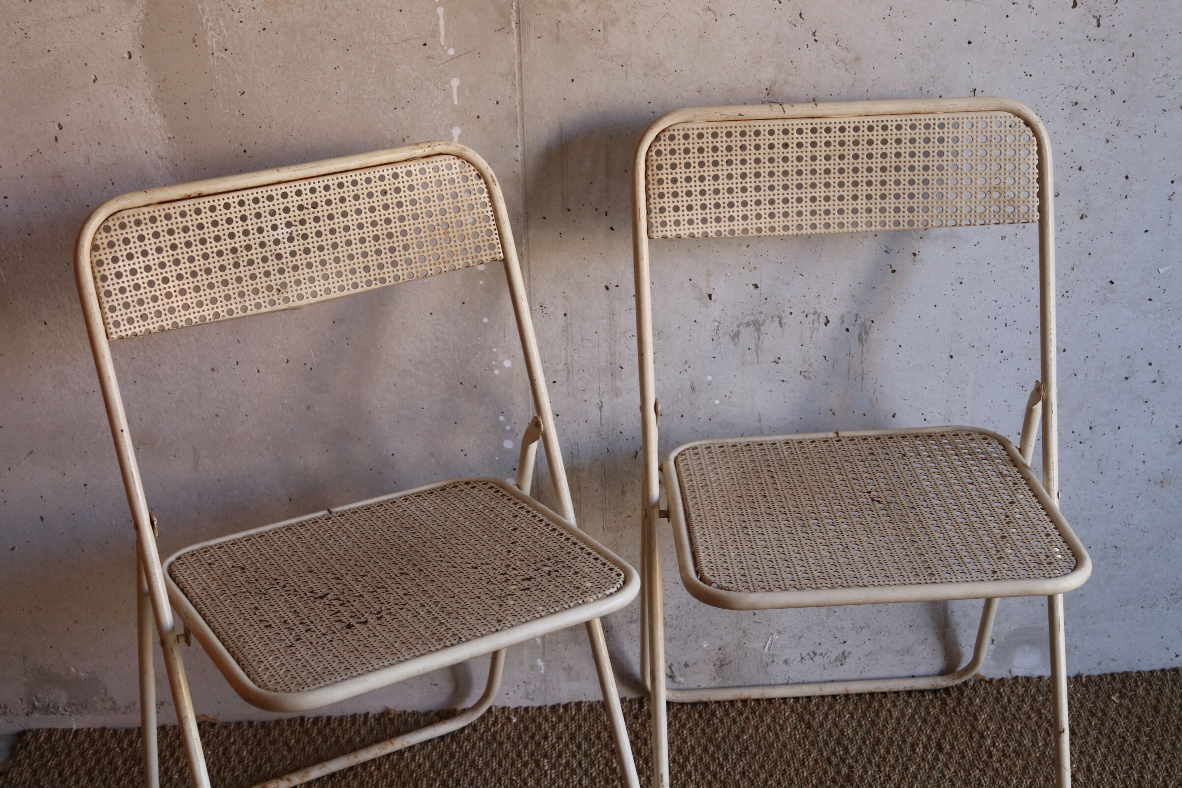 Two metal tanned folding chairs