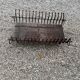 Vintage cast iron fireplace cradle with 16 bars.