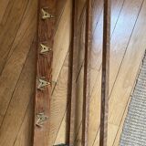 Vintage wall-mounted coat rack with five brass hooks
