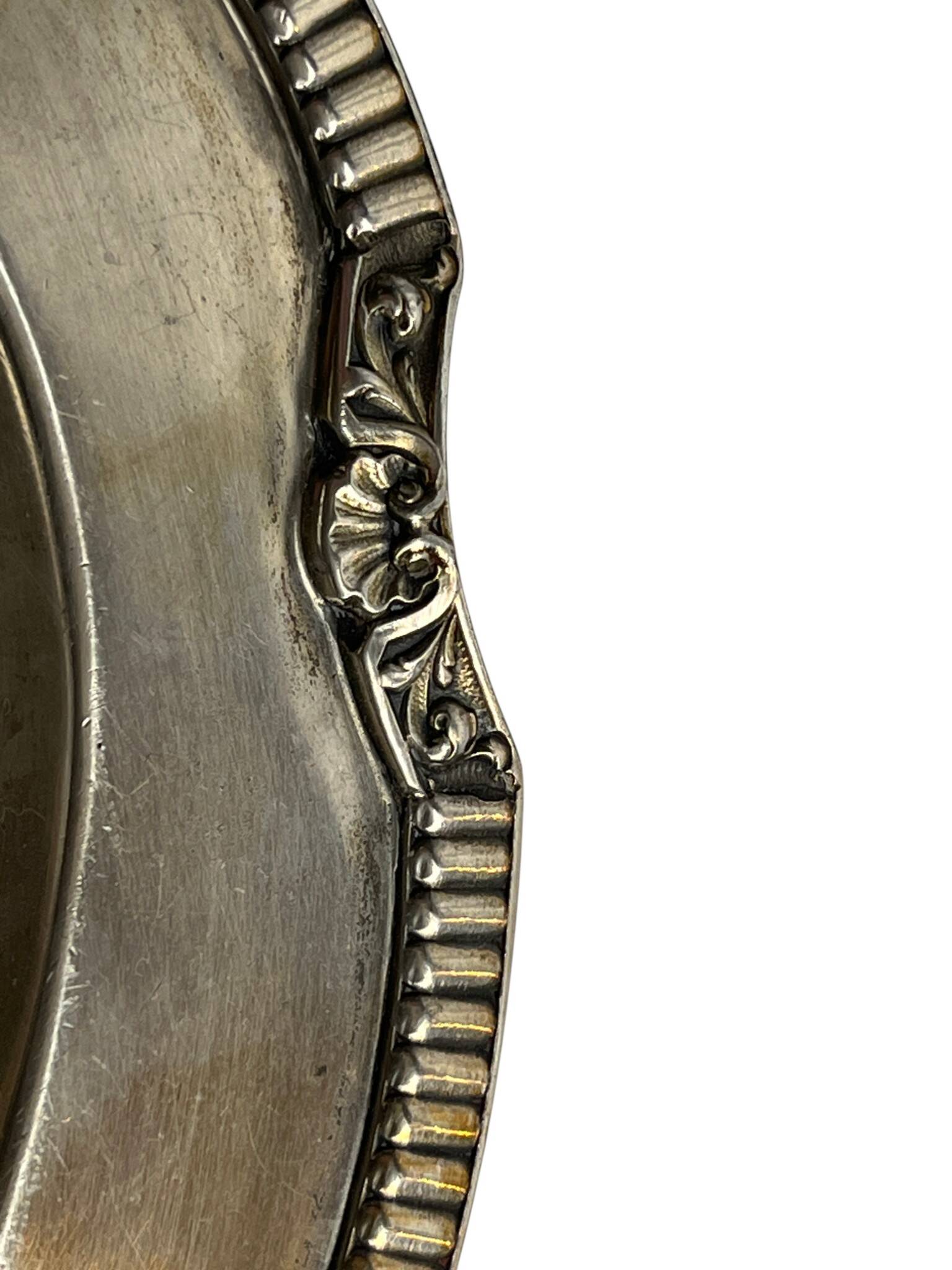 Oval metal silver-plated tray with hallmarks from the early 20th century.