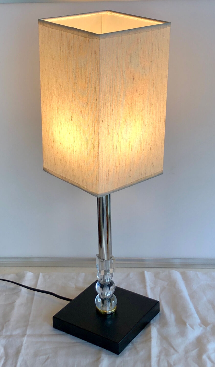 Silver floor lamp with a straight shade.