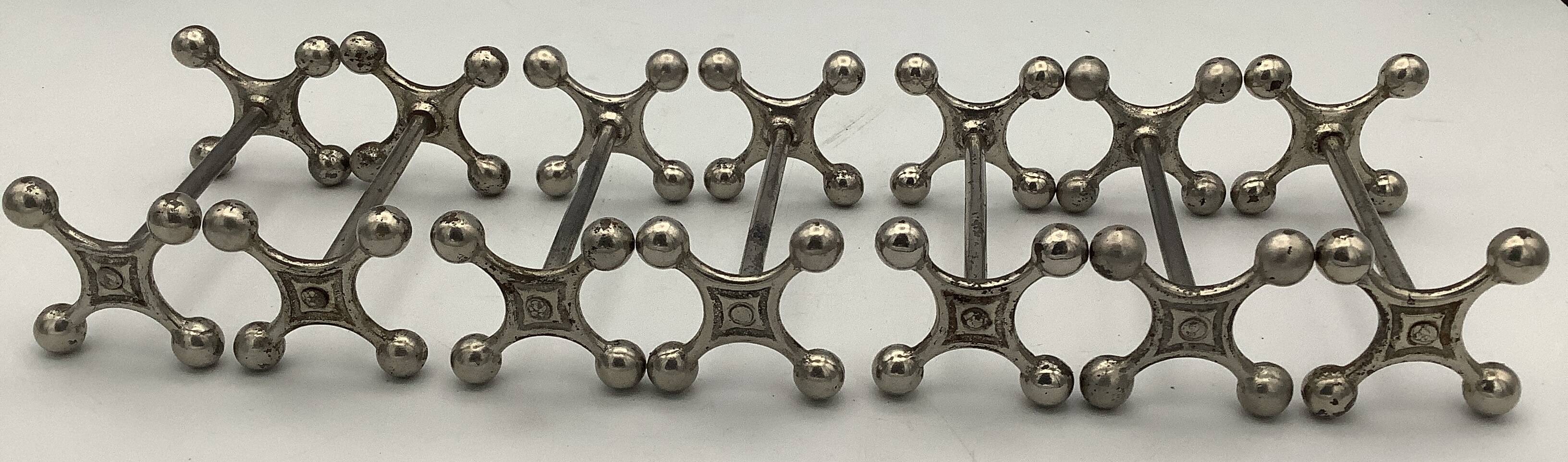Set of 7 vintage knife rests in the shape of crosses in silver-plated metal.