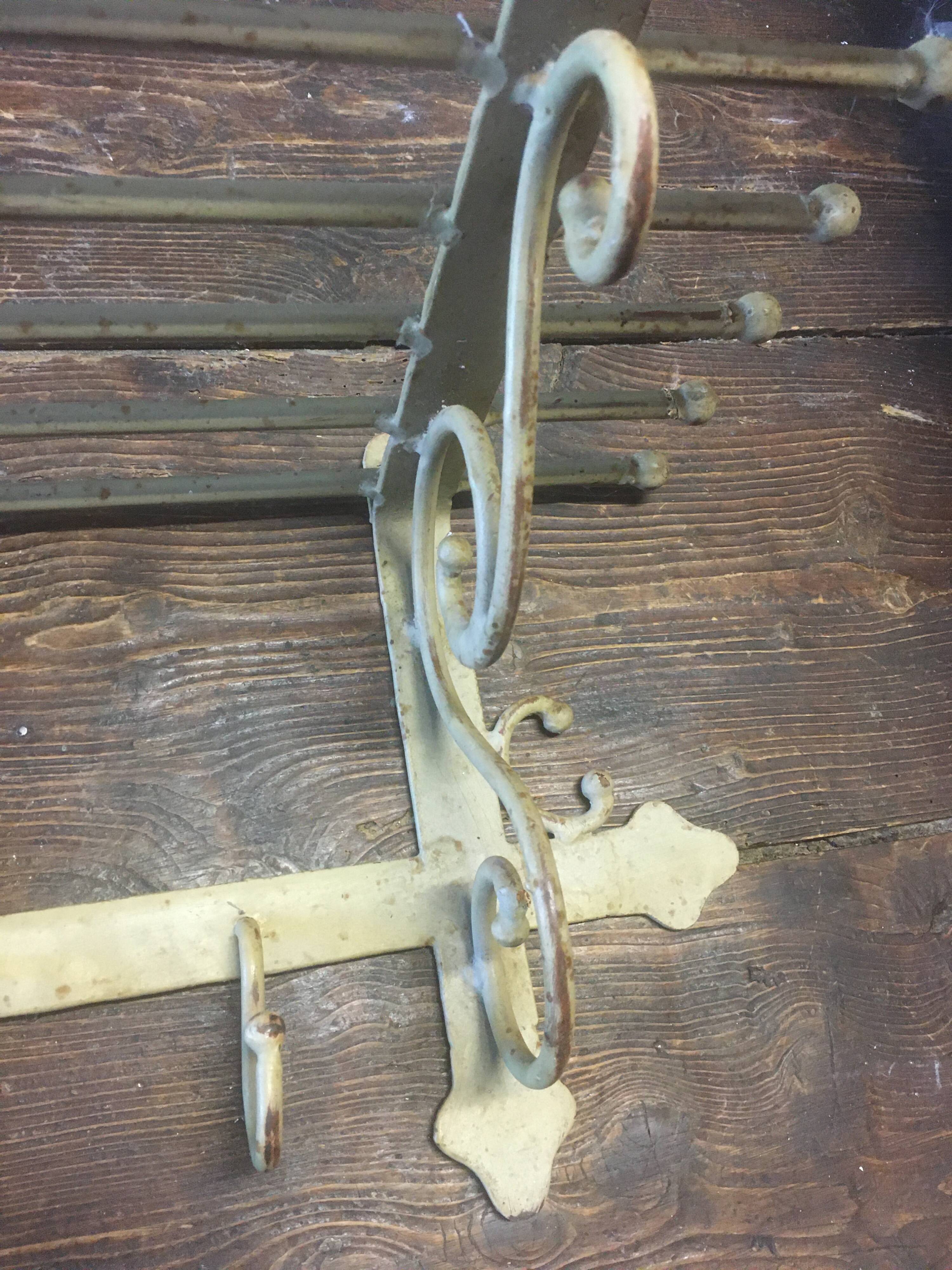 White wrought iron coat and hat rack