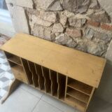 On a piece of furniture with sorting lockers and drawers