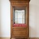 Vintage wooden display cabinet with glass shelves.