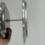 Three-tiered serving trolley in shiny stainless steel.