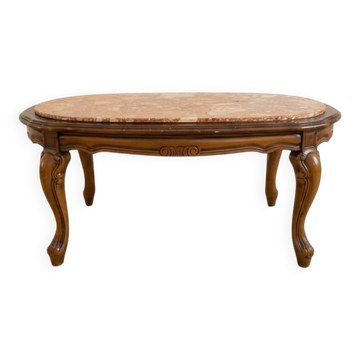 Oval coffee table in marble and carved wood in baroque style.