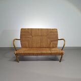 Vintage French papercord sofa with a metal frame base