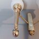 Neoclassical Torch two-arm wall lamp in solid brass, circa 1940