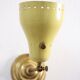 Wall lamp inlaiton and pale yellow lacquered metal