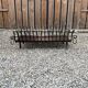 Vintage cast iron fireplace cradle with 16 bars.
