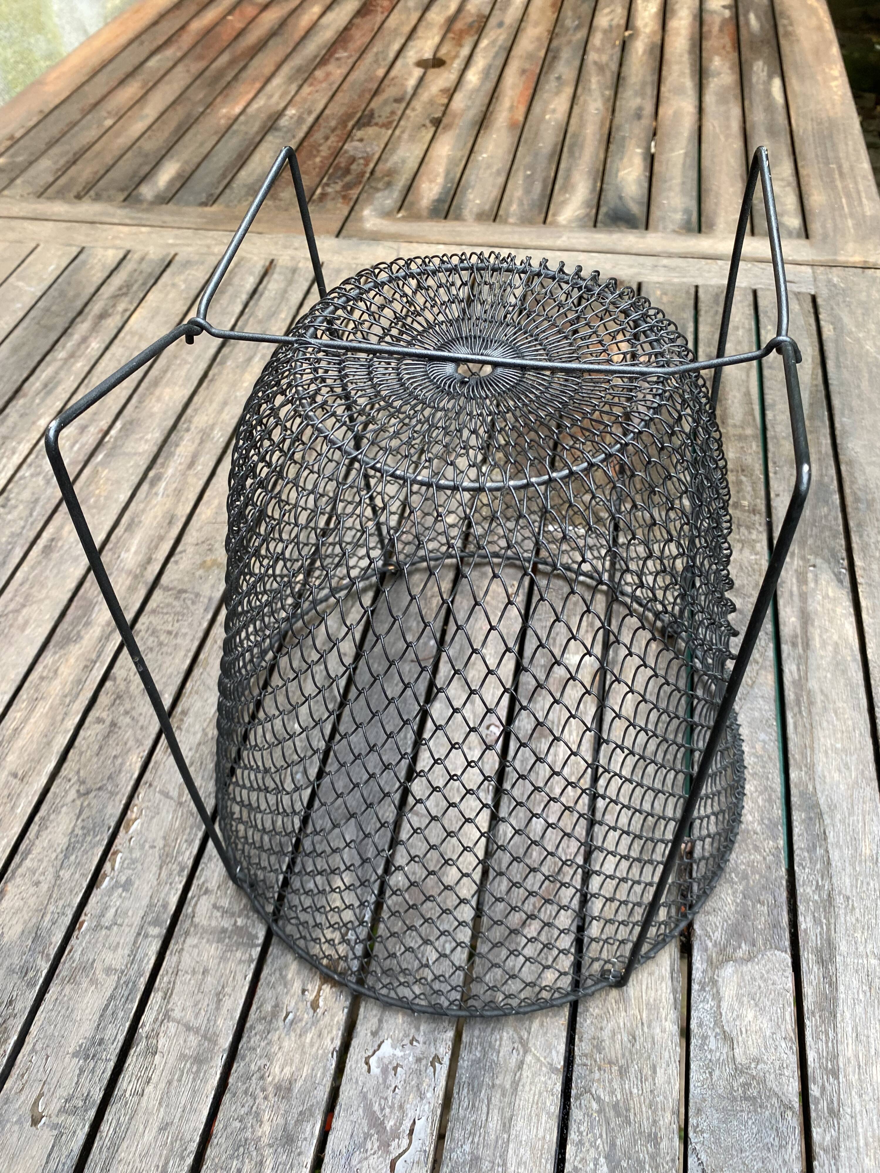 Foldable black woven metal wastepaper basket from around 1950.